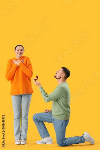 Young man proposing to his ...