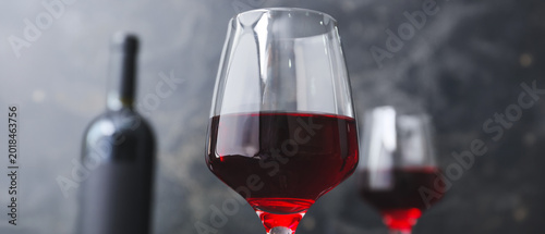 Glass of red wine on dark b...