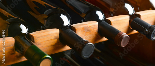 Bild auf Leinwand Wooden holder with bottles of wine in cellar
