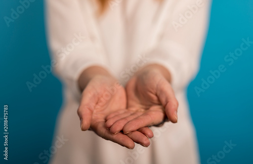 Fotografie Woman's hands outstretched, palms up, offering something