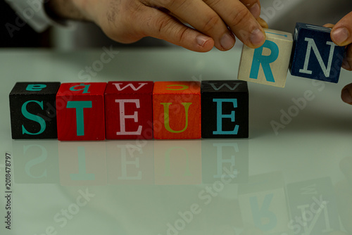 Hands placing wooden letter...