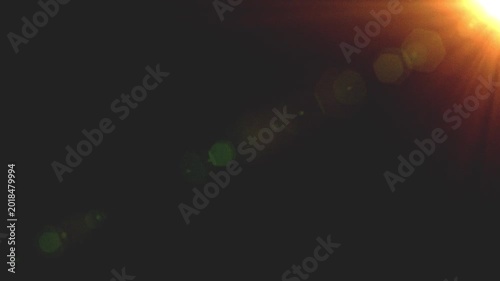 Cinematic Sun Lens Flare Warm Realistic Overlay Loop on Dark Background, Real camera animated effect, Dynamic Sunlight motion Graphics Filter