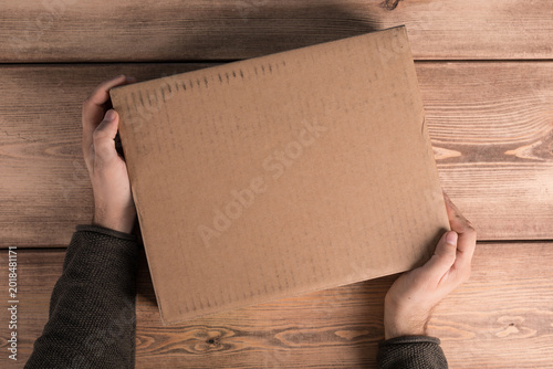 Person holding a plain brow...