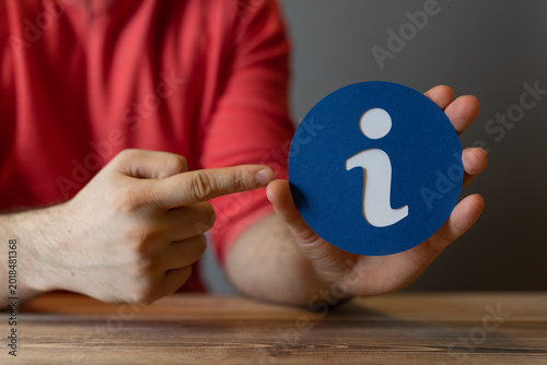 Φωτογραφία Hand holding an info symbol, suggesting knowledge and guidance