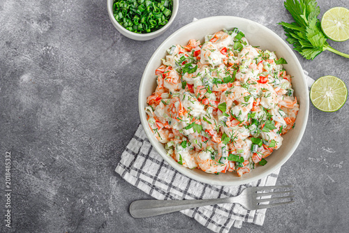 Creamy Shrimp and Crab Salad with Fresh Herbs in Bowl on Rustic Grey Background