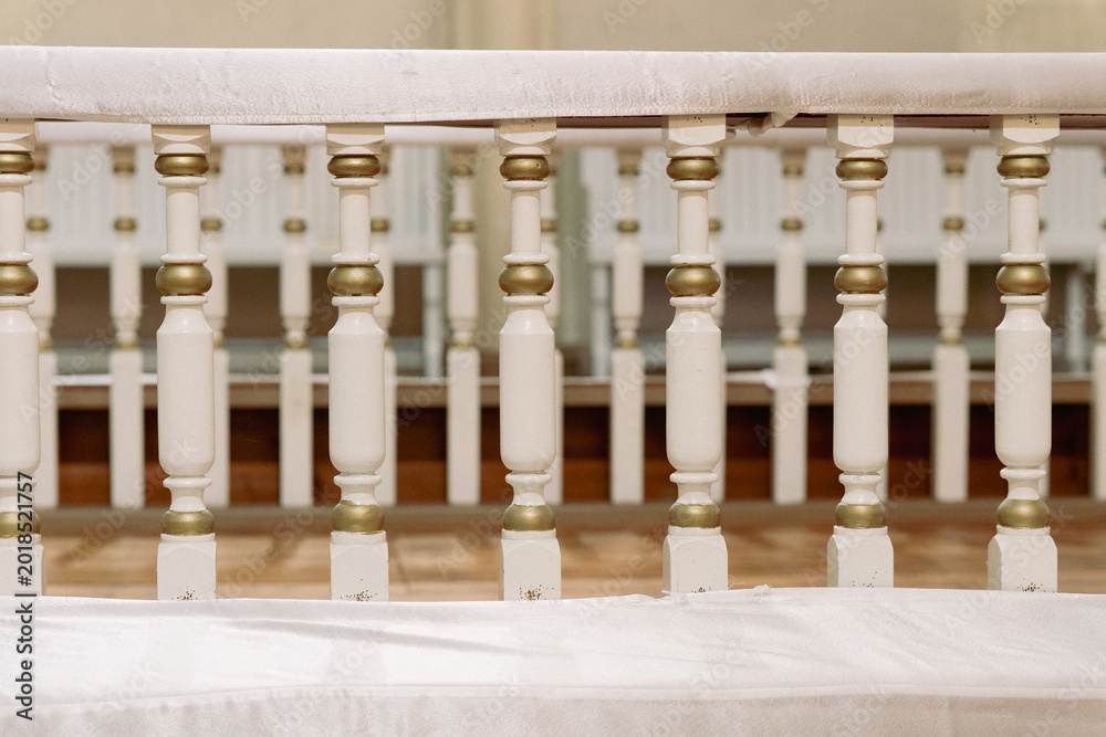 Fototapeta premium Decorative wooden altar railing inside historic Christian church interior