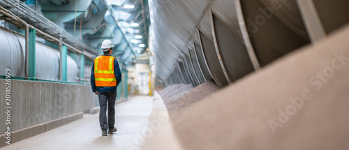 Worker inspecting industrial conveyor system