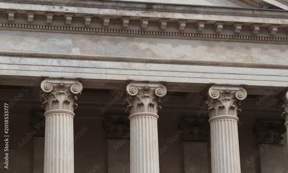 Obraz premium three worn neoclassical columns supporting faded entablature intricate details soft diffused sunlight casting subtle