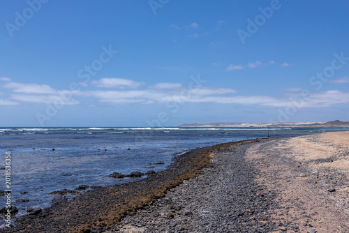 The beautiful beach of Ponta Preta (English translation: Black Beack) is a tranquil part of Sal Island in Cape Verde without many tourists but with a perfect golden sand beach and turqiouse water crea