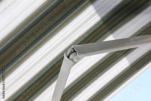 Fotografie Close up outdoor automatic sliding canopy retractable roof system, patio awning