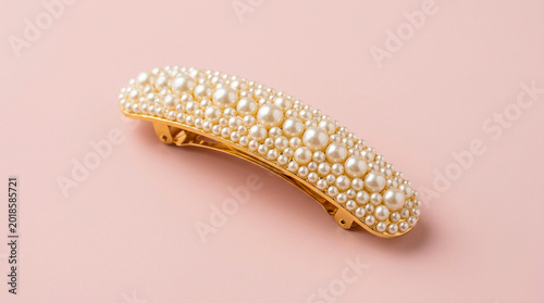 Elegant golden hair clip adorned with many shiny white pearls in this beautiful studio product photo