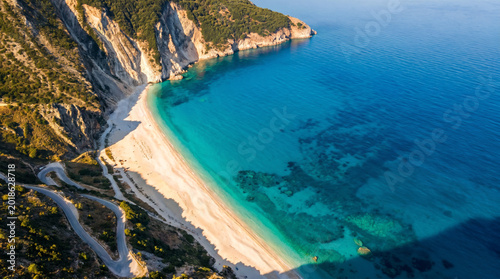 Aerial view of Myrtos Beach, a stunning white pebble beach with turquoise waters and dramatic cliffs on Kefalonia Island, Greece.