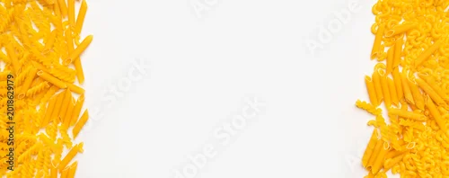 Panel kuchenny z motywem Dry uncooked Italian pasta scattered on white background. Spiral pasta, fusilli, penne. Food background, organic macaroni. Free space for your text, long banner