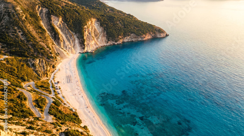Aerial view of Myrtos Beach, a famous destination on Kefalonia island, Greece, with turquoise waters and white pebble shore.