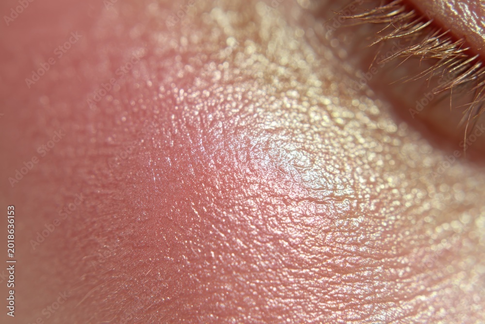 Fototapeta premium Macro Shot of Human Skin Texture with Subtle Iridescent Sheen.
