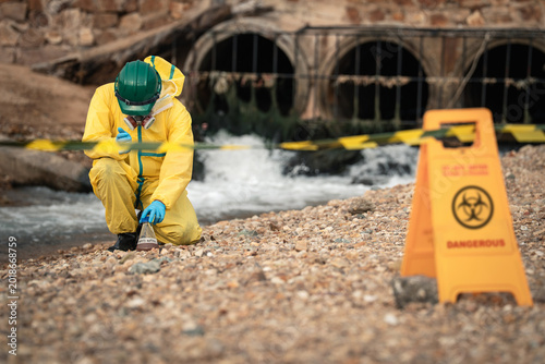 Environmental Worker Inspecting Industrial Hazard Zone During Wastewater Pollution Monitoring And Environmental Safety Assessment Near Drainage Area