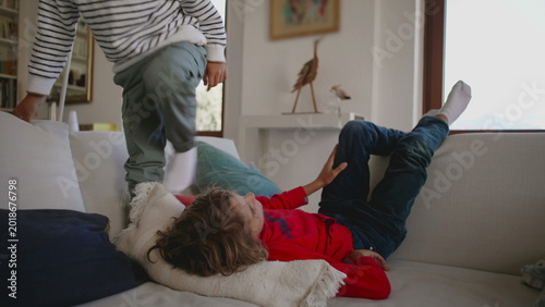 Photography Child lying back on living room sofa resting quietly with relaxed posture, creat