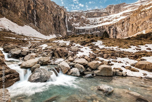 Snow melt cascades down a stream from the Cirque de Gavarnie in the French Pyrenees mountains