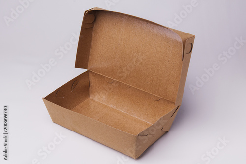 Open empty brown kraft paper takeaway food box isolated on white background