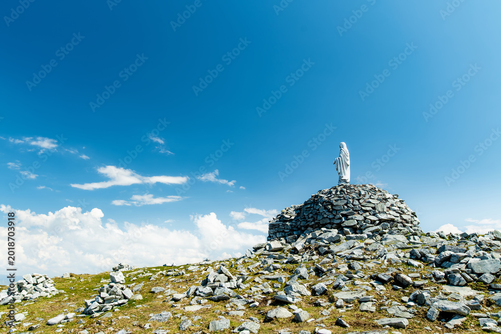 Naklejka premium Statue of the Virgin Mary on Minaun Heights, Achill Island, County Mayo, Ireland. Rocky mountain summit with sweeping Atlantic views on the Wild Atlantic Way.