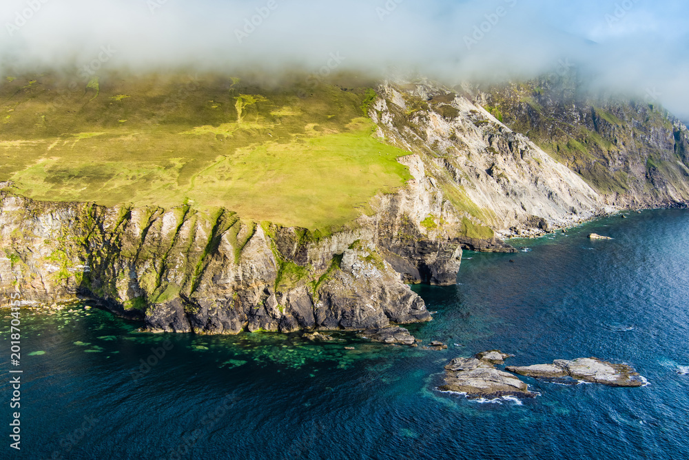 Obraz premium Aerial view of the southern end of Keel Beach on Achill Island, County Mayo, Ireland. White pebbles, turquoise water and steep cliffs define this rugged Atlantic cove.
