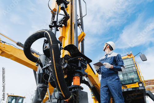 Foto Offshore worker inspect with tablet drilling rig for exploration of minerals for oil, gas and artisan water