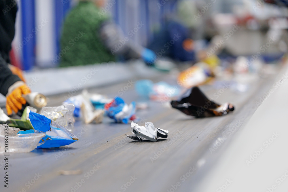 Obraz premium Recycling center conveyor belt sorting plastic waste indoors