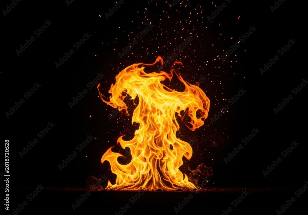 Fototapeta premium Bright orange flames rising against a black background with glowing embers and sparks
