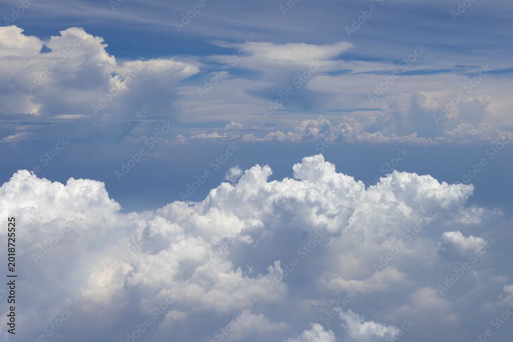 Fototapeta premium A stunning aerial view showcasing towering cumulus clouds against a brilliant blue sky. This image captures the beauty and scale of atmospheric formations.