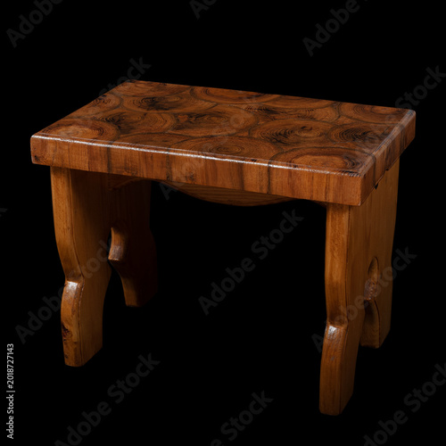 handmade wooden stool isolated on black background