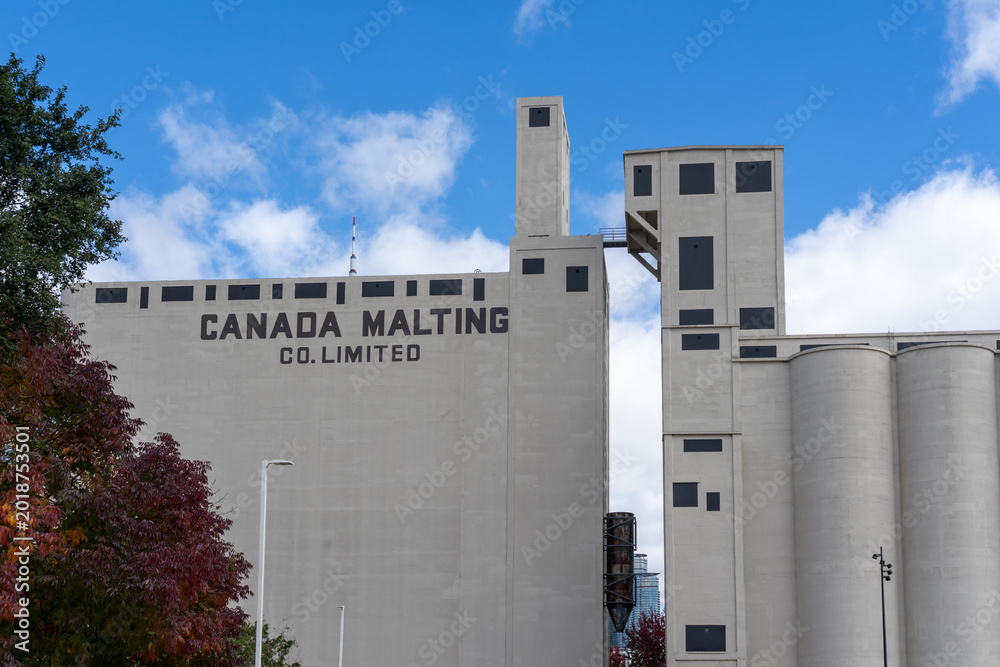 Naklejka premium Toronto, Canada-October 16, 2024: Canada Malting Silos, built in 1928, is one of two remaining silos in Toronto. It was abandoned in the 1980s. and it is designated a heritage site.