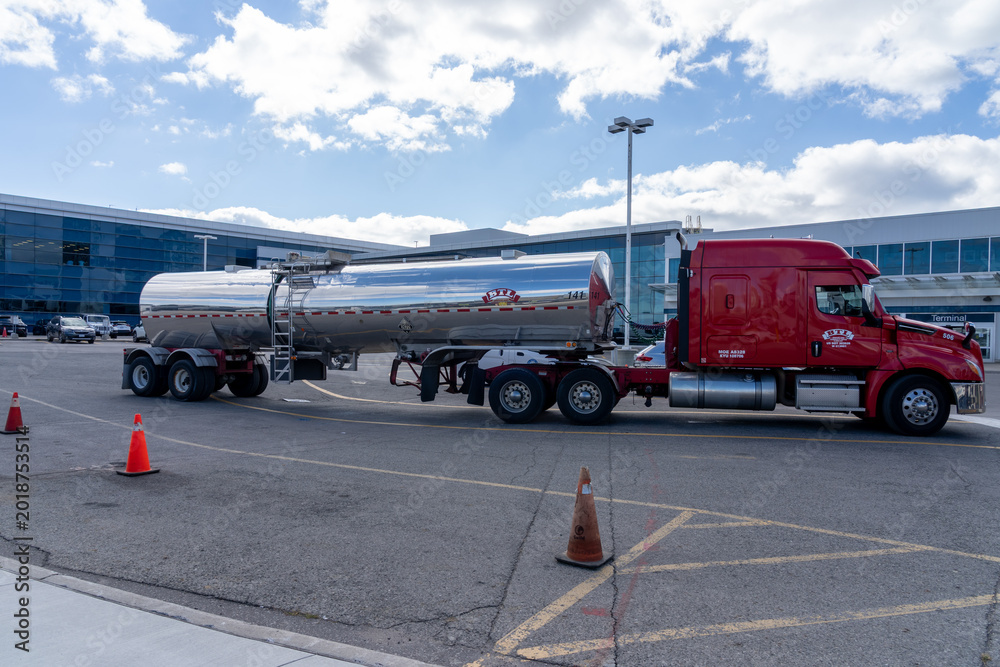 Fototapeta premium Toronto, Canada - October 16, 2024: A BTL tank truck at Billy Bishop Toronto City Airport on Toronto Islands in Toronto, Ontario, Canada. Bridgeland Terminals (BTL) is a Tank Truck Transportation co
