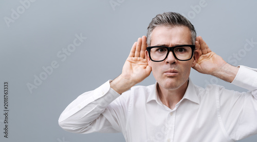 Man listening to a loud noise