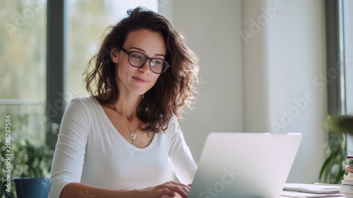 Remote work inspiration young woman working on laptop in modern home office bright and cozy environment