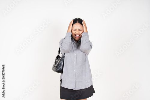 фотографія Woman holds head, eyes closed, face contorted in distress