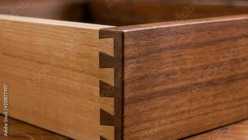 dovetail. Close-up of a handcrafted wood dovetail joint showing fine wood grain. real-estate listings, architecture portfolios, designed for real-estate listing and luxury residence showcases.
