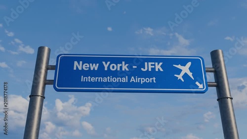 Blue Road Sign for New York JFK International Airport with Airplane Flying Overhead