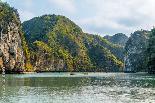 Schilderij op canvas A view of tourist sampans in an internal bay surrounded by Karst limestone cliff