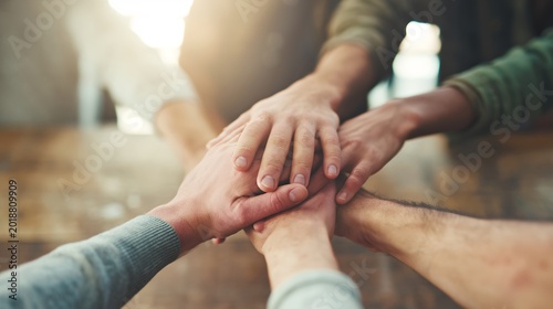 Group of people joining hands in circle