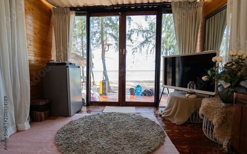 White curtains are hung to block sunlight and decorate the interior of the room.