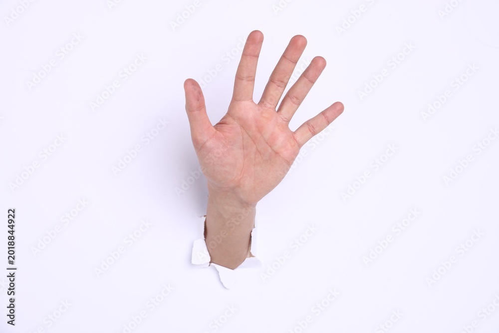 Naklejka premium Man showing palm through hole in white paper, closeup