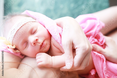 Photos A newborn baby lies in her mother's arms