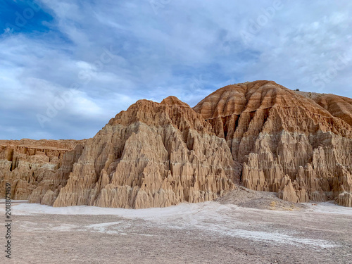 Valokuva Towering eroded clay and sandstone formations beneath dramatic clouds at Cathedral Gorge State Park in Nevada’s high desert landscape