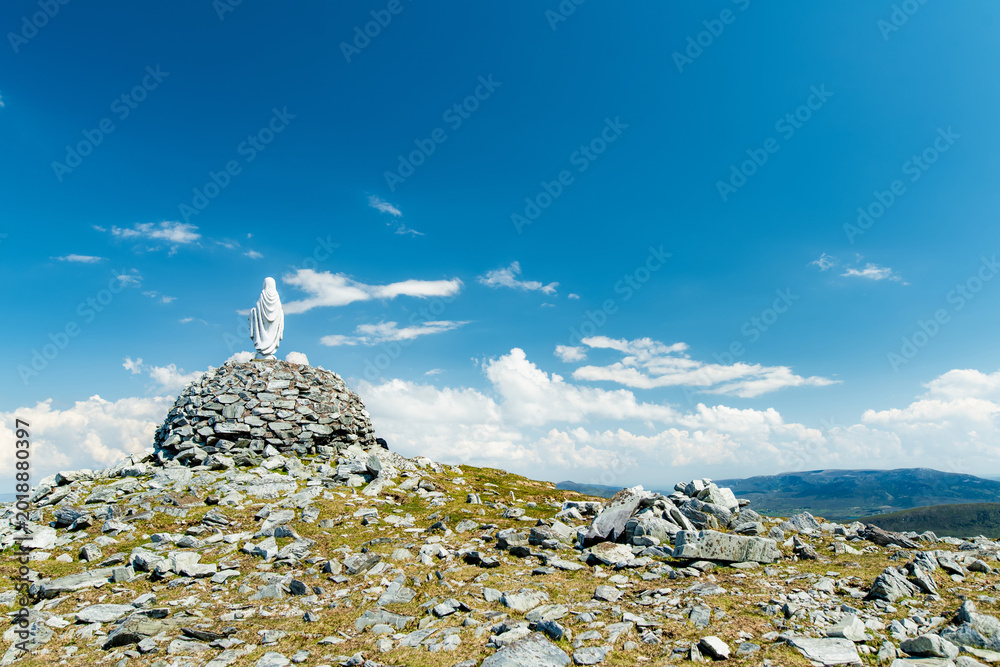 Naklejka premium Statue of the Virgin Mary on Minaun Heights, Achill Island, County Mayo, Ireland. Rocky mountain summit with sweeping Atlantic views on the Wild Atlantic Way.