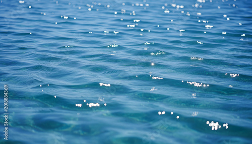 Image of a blue water surface with a pattern of small%2C sparkling waves.