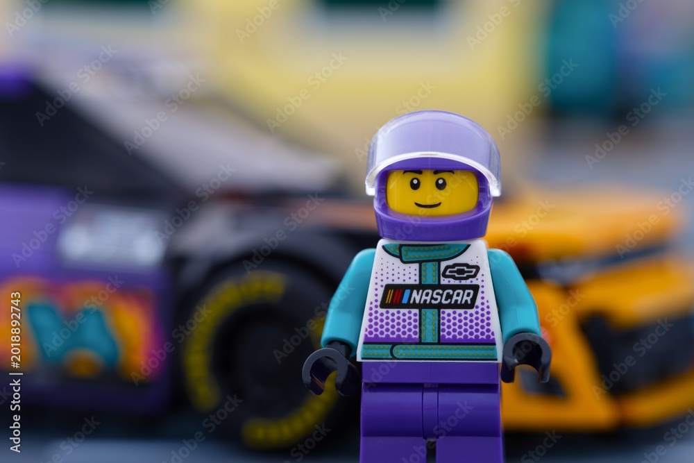 Obraz premium Tambov, Russian Federation - January 02, 2026 Portrait of Lego NASCAR Next Gen Chevrolet Camaro ZL1 driver minifigure standing near his car. LEGO Speed Champions.