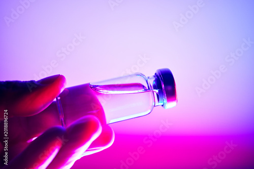 Hand holding glp 1 medication vial for obesity treatment