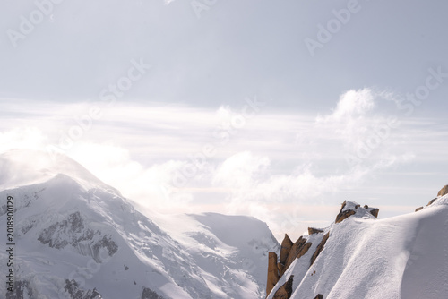Bild auf Leinwand Cloud Brushing Across Snowy Peaks at Aiguille du Midi