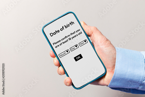 Hand holding smartphone confirming age verification