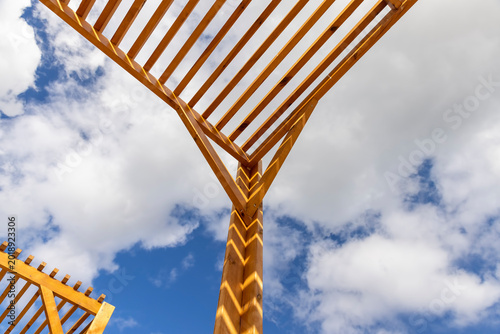 Tableau sur toile a wooden frame on the beach in sunny weather against a blue sky with clouds, par